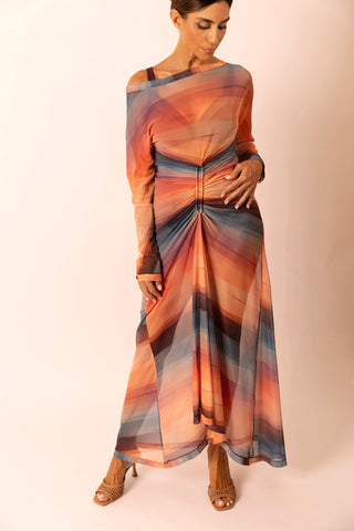 Mature woman wearing a long sunset stripe print mesh dress with long sleeves